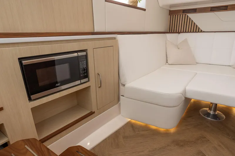 Slide: The Image of Manufacturer Provided Image: Luxurious interior of 2026 Regal 43 SAV yacht with modern seating and built-in microwave. - 14