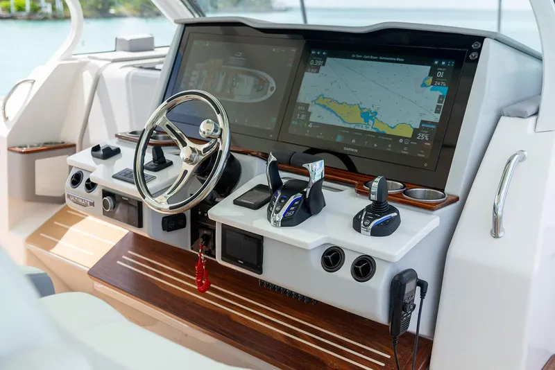 Slide: The Image of Manufacturer Provided Image: Control panel of 2026 Regal 43 SAV boat with navigation screens and steering wheel. - 6