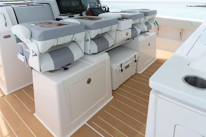 Slide: The Image of Manufacturer Provided Image: 2026 Regal 43 SAV boat interior with cushioned seating and storage compartments. - 8