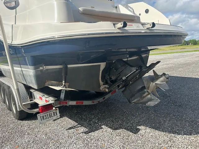 Slide: The Image of 2013 Rinker 290 Express Cruiser on trailer, rear view showing propeller and license plate. - 5