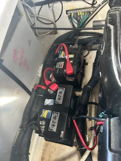 Slide: The Image of 2013 Rinker 290 Express Cruiser engine compartment with batteries and wiring. - 8