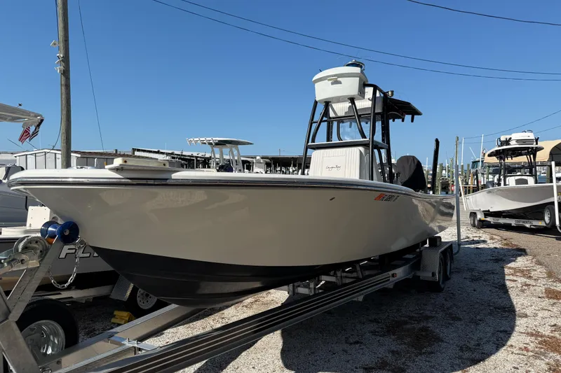 The Image of 2022 Canyon Bay 28h boat on trailer in marina under clear blue sky. - 1