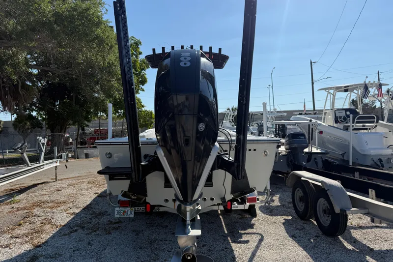 Slide: The Image of 2022 Canyon Bay 28h boat with powerful outboard motor, parked on gravel lot. - 11