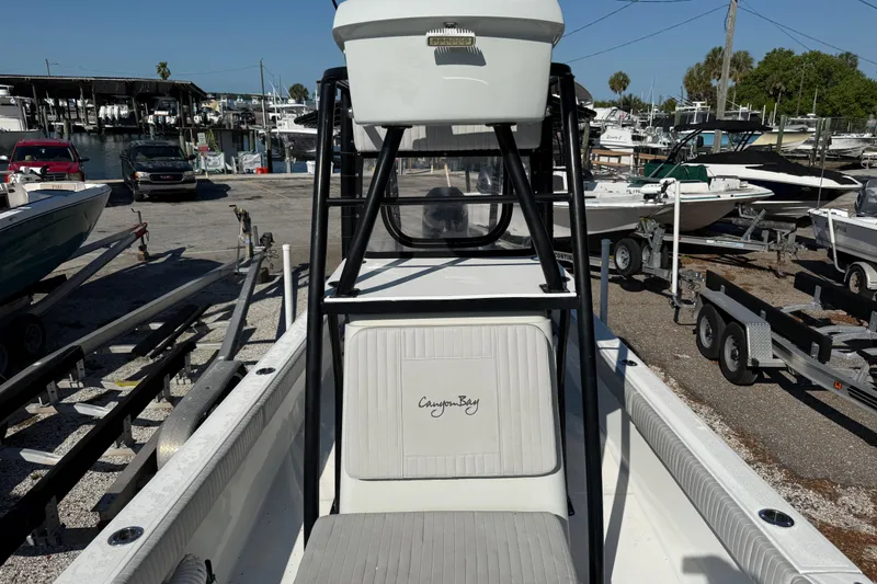 Slide: The Image of 2022 Canyon Bay 28h boat at a marina with trailers and other boats. - 4