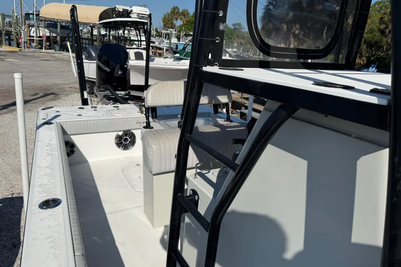 Slide: The Image of 2022 Canyon Bay 28h boat with seating and ladder, docked at marina. - 5