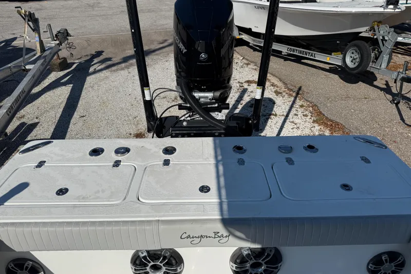 Slide: The Image of 2022 Canyon Bay 28h boat with Mercury engine, parked on a trailer. - 8
