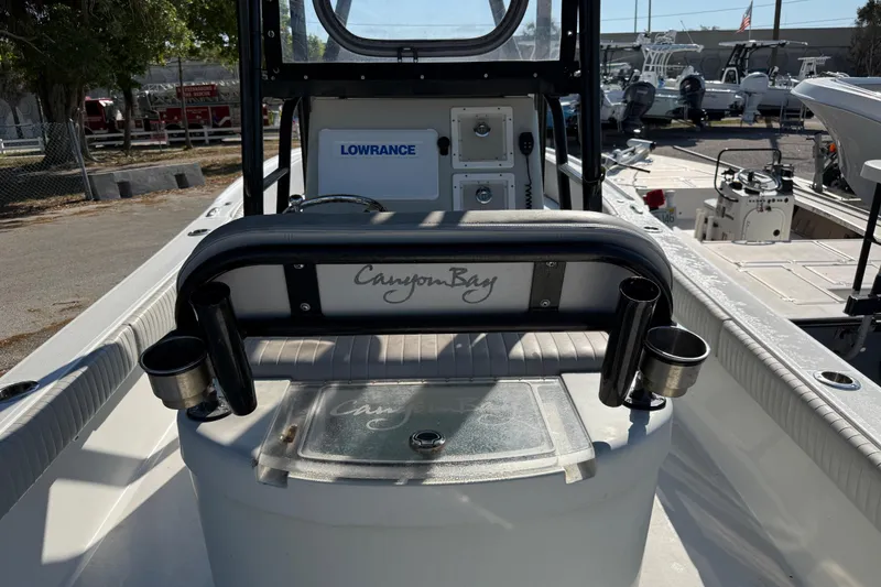 Slide: The Image of 2022 Canyon Bay 28h boat interior with Lowrance equipment and rod holders. - 9
