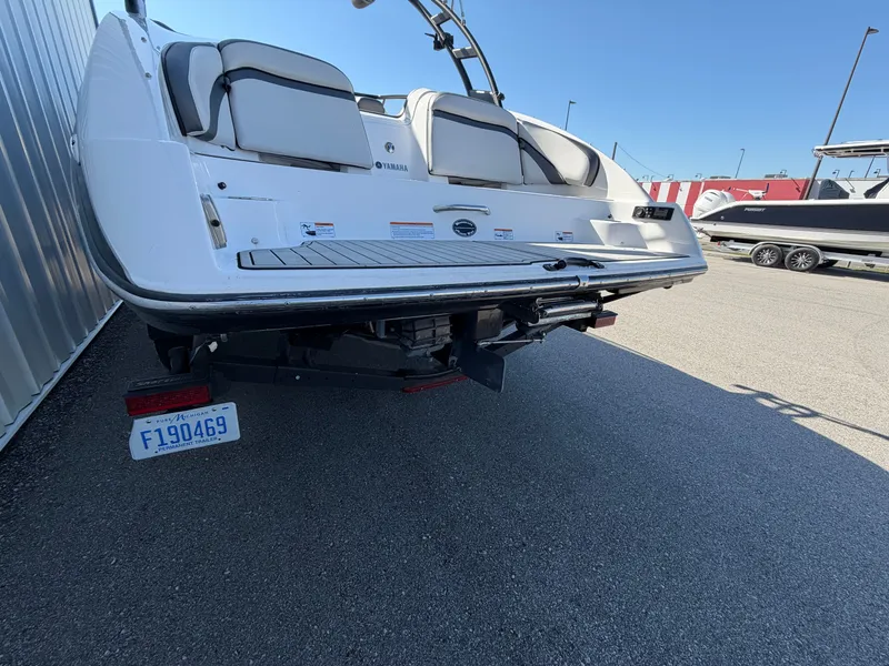 Slide: The Image of Rear view of a 2020 Yamaha AR240 boat on a trailer. - 13