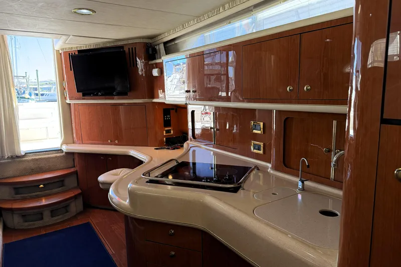 Slide: The Image of Luxurious interior of a 2000 Sea Ray 450 Express Bridge yacht with modern kitchen amenities. - 10