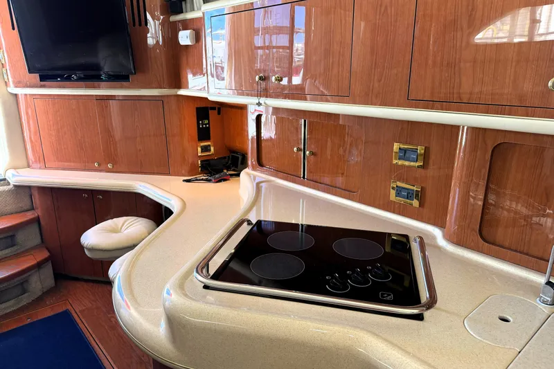 Slide: The Image of Interior of 2000 Sea Ray 450 Express Bridge yacht with modern kitchen amenities. - 11
