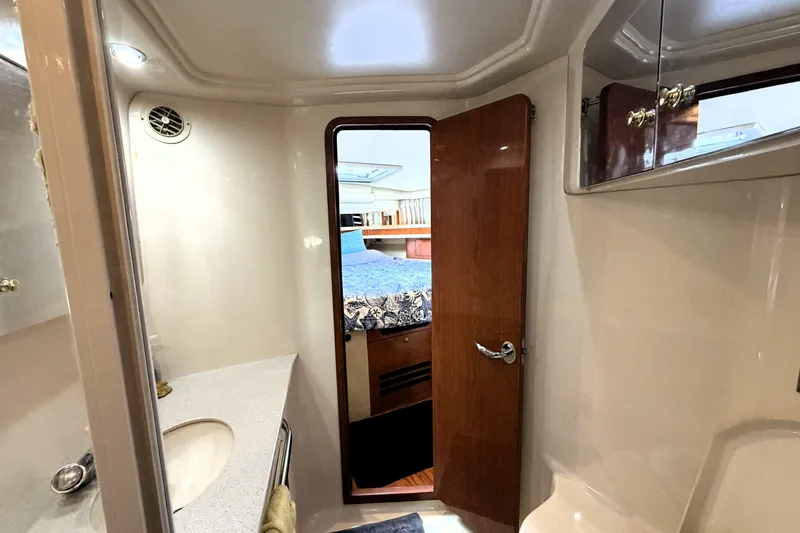 Slide: The Image of Interior of 2000 Sea Ray 450 Express Bridge, featuring bathroom and bedroom view. - 16