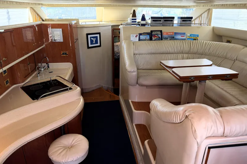 Slide: The Image of Interior of 2000 Sea Ray 450 Express Bridge with kitchen and seating area. - 2