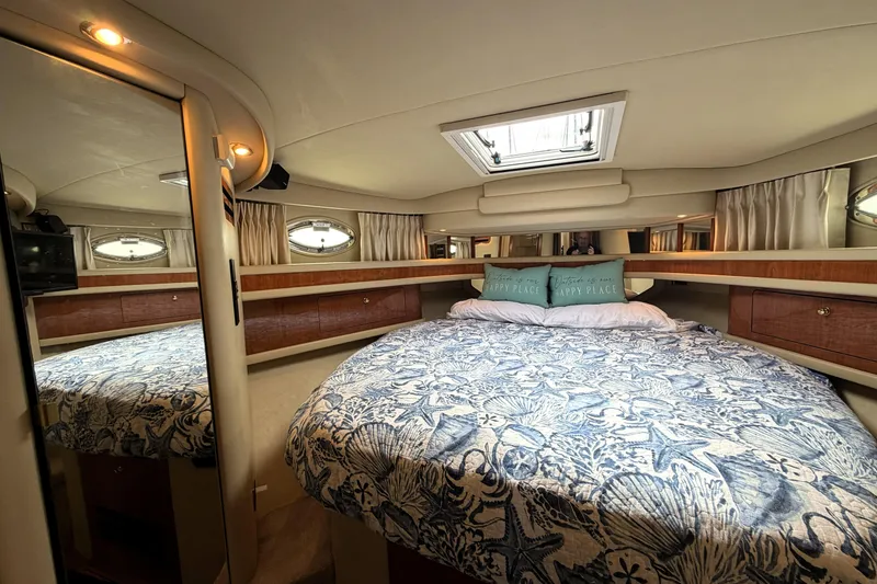 Slide: The Image of Luxurious cabin interior of 2000 Sea Ray 450 Express Bridge with cozy bedding. - 20