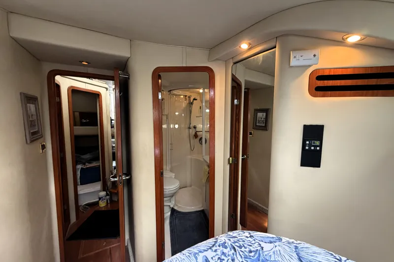 Slide: The Image of Interior of 2000 Sea Ray 450 Express Bridge yacht, featuring a cozy cabin and bathroom. - 26