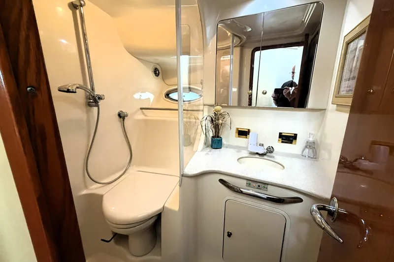 Slide: The Image of Bathroom interior of 2000 Sea Ray 450 Express Bridge yacht, featuring shower and vanity. - 37
