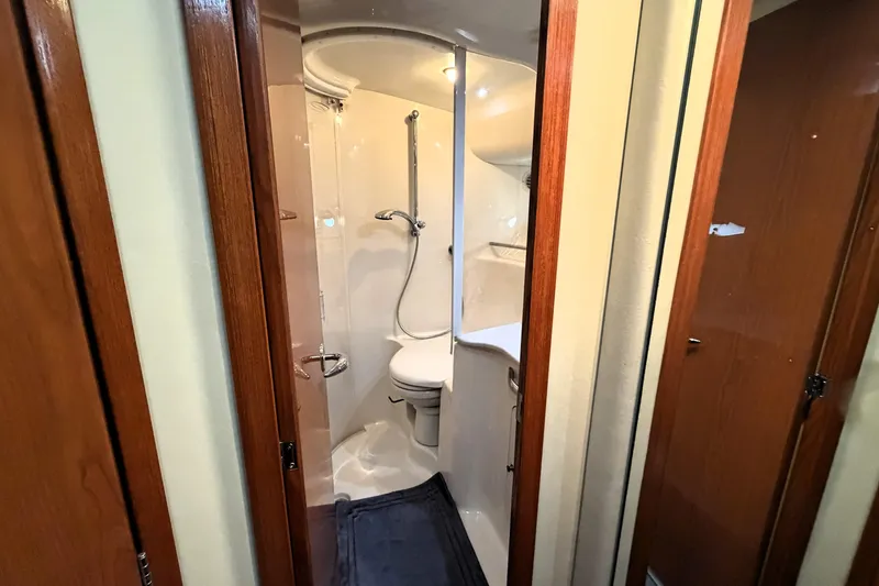 Slide: The Image of Bathroom interior of 2000 Sea Ray 450 Express Bridge yacht, featuring shower and toilet. - 38
