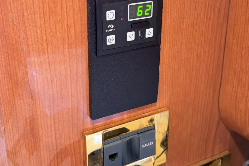 Slide: The Image of Control panel on 2000 Sea Ray 450 Express Bridge yacht interior, displaying temperature settings. - 42