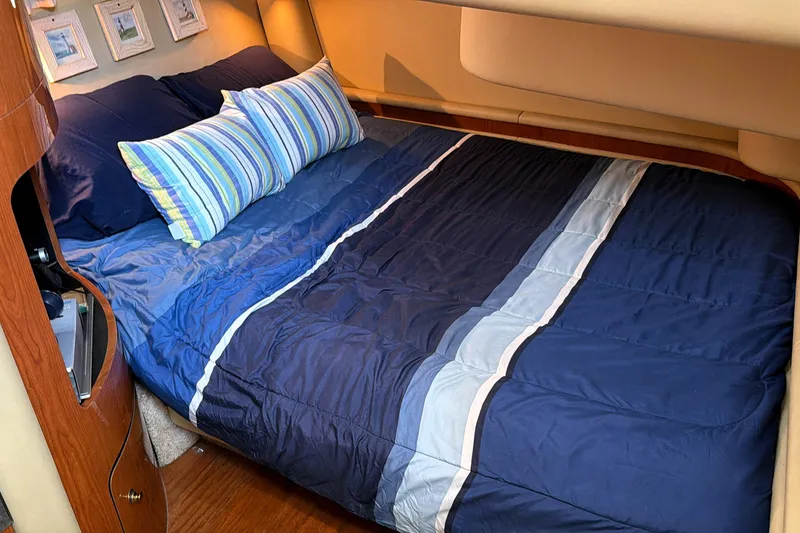 Slide: The Image of Luxurious cabin interior of 2000 Sea Ray 450 Express Bridge with cozy bedding. - 52