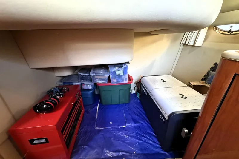 Slide: The Image of Interior storage area of a 2000 Sea Ray 450 Express Bridge with organized containers. - 53