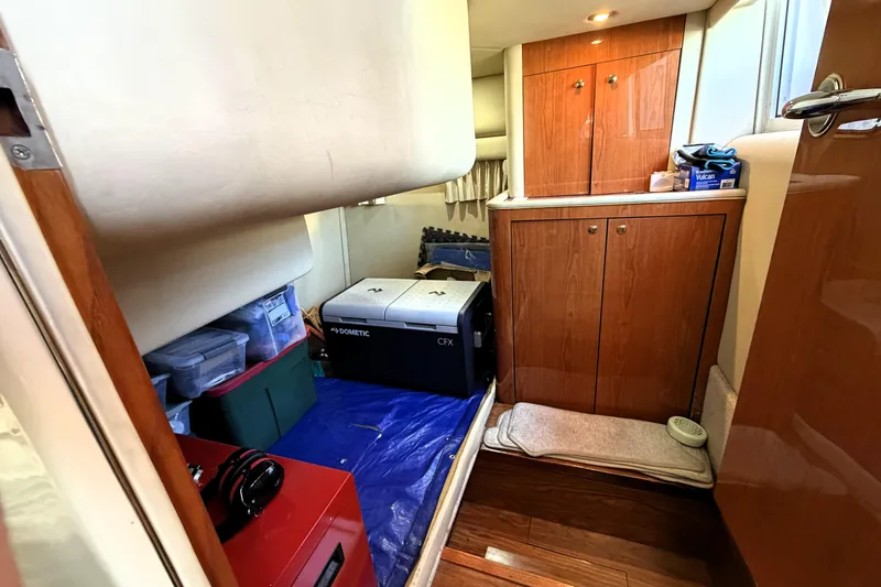 Slide: The Image of Interior cabin of 2000 Sea Ray 450 Express Bridge with storage and Dometic cooler. - 55