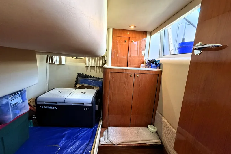 Slide: The Image of Interior cabin of a 2000 Sea Ray 450 Express Bridge with storage and Dometic cooler. - 56