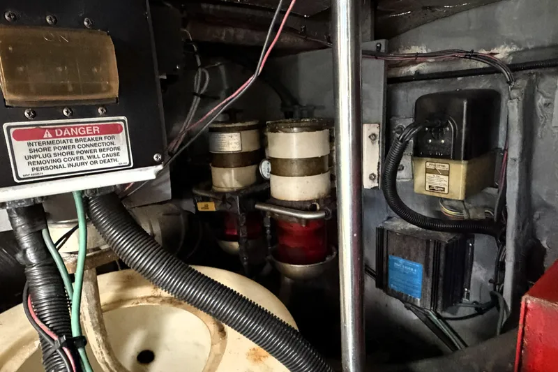 Slide: The Image of Engine room of 2000 Sea Ray 450 Express Bridge with electrical components and warning sign. - 57