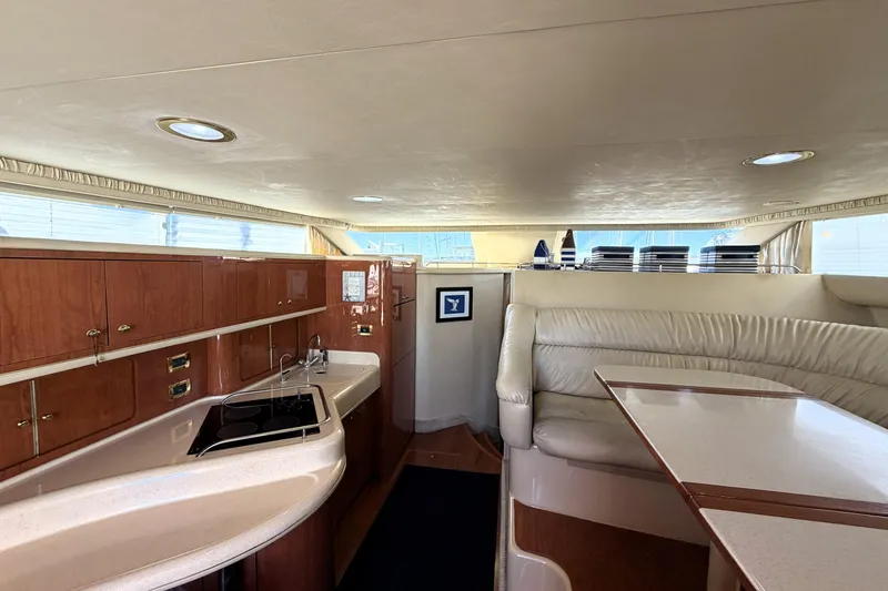 Slide: The Image of Interior of 2000 Sea Ray 450 Express Bridge yacht with kitchen and seating area. - 6