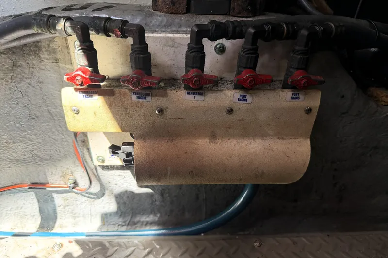 Slide: The Image of Engine control panel with labeled valves on a 2000 Sea Ray 450 Express Bridge. - 66