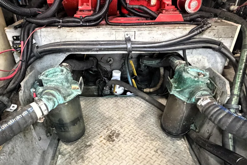 Slide: The Image of Engine compartment of a 2000 Sea Ray 450 Express Bridge with visible hoses and components. - 68