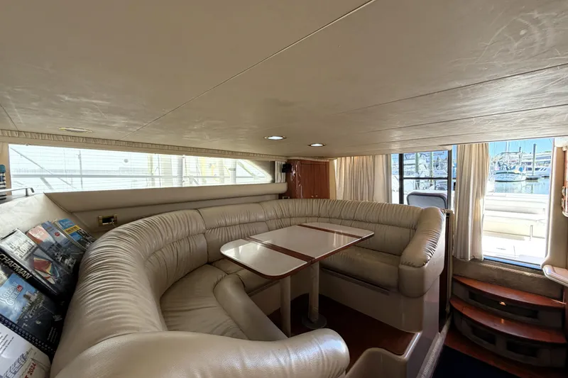 Slide: The Image of Luxurious interior of 2000 Sea Ray 450 Express Bridge yacht with plush seating and table. - 7
