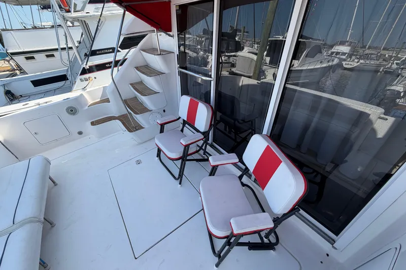 Slide: The Image of Interior storage area of a 2000 Sea Ray 450 Express Bridge with organized containers. - 73