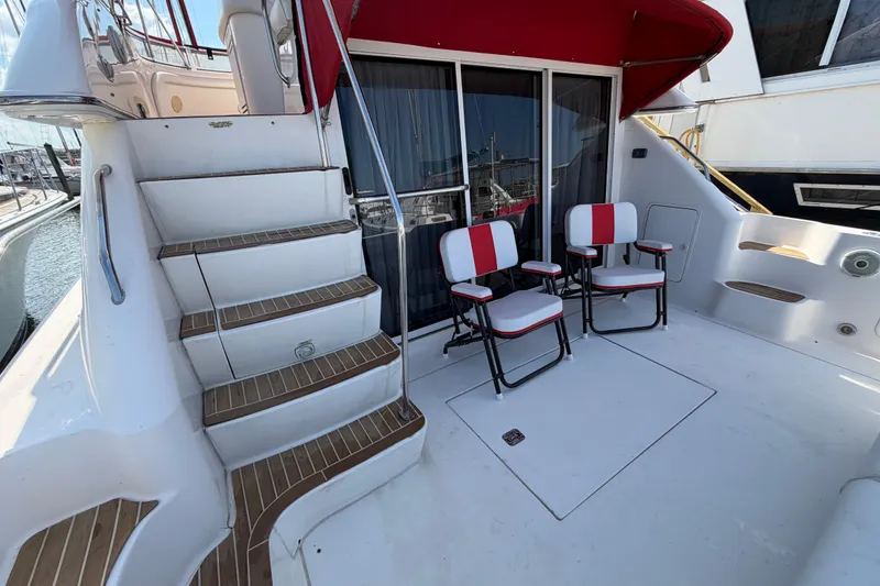 Slide: The Image of Interior storage area of a 2000 Sea Ray 450 Express Bridge with various containers and equipment. - 74