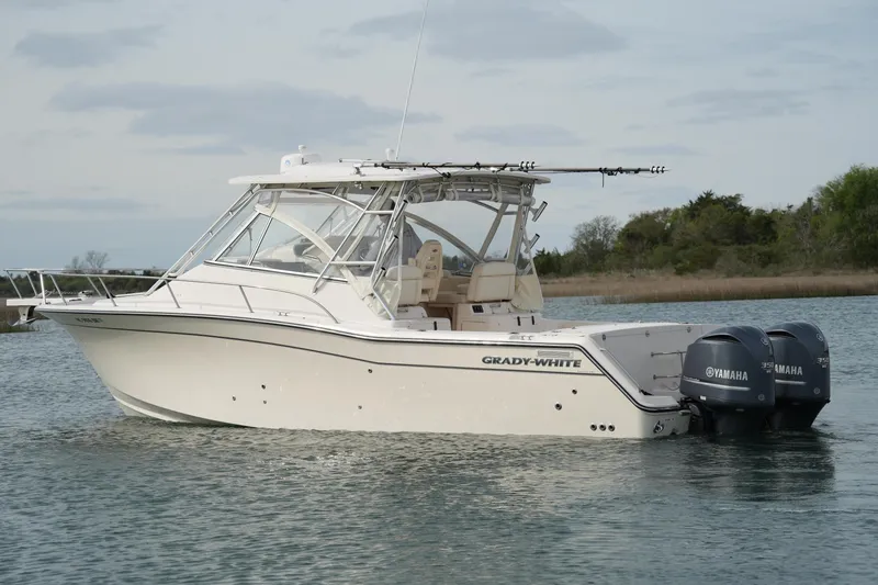 Slide: The Image of 2009 Grady-White Express 330 boat with twin Yamaha engines on water. - 10