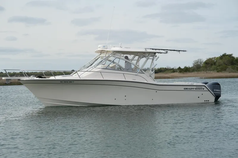 Slide: The Image of 2009 Grady-White Express 330 boat on calm water, side view. - 11