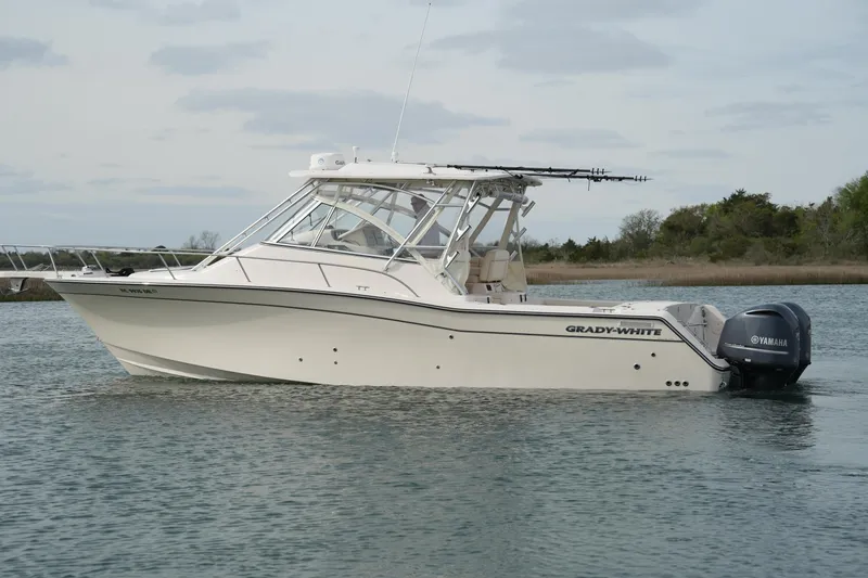 Slide: The Image of 2009 Grady-White Express 330 boat with Yamaha engines on calm water. - 13