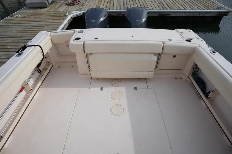 Slide: The Image of 2009 Grady-White Express 330 boat deck with twin outboard motors at dock. - 14