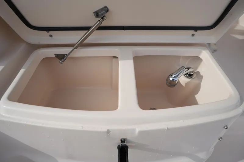 Slide: The Image of 2009 Grady-White Express 330 boat sink and storage compartment. - 19
