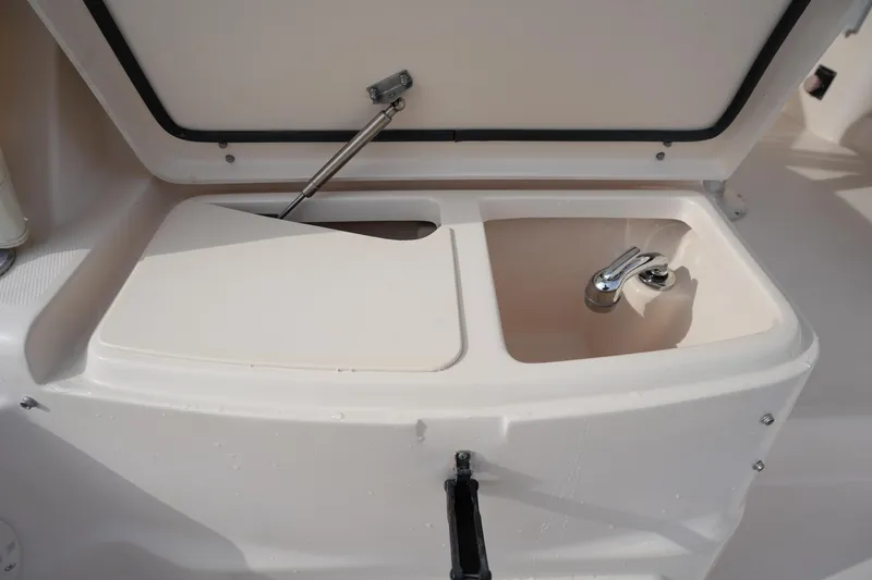 Slide: The Image of Open storage compartment with sink on 2009 Grady-White Express 330 boat. - 20