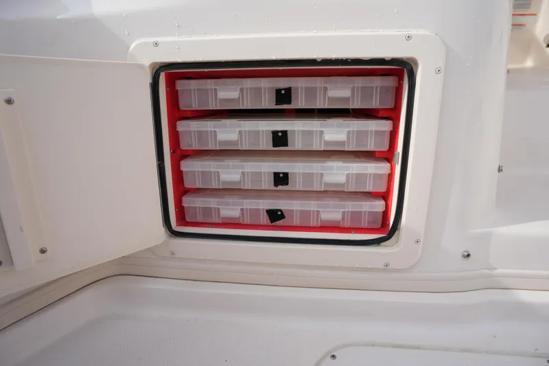 Slide: The Image of Storage compartment with tackle boxes on a 2009 Grady-White Express 330 boat. - 21