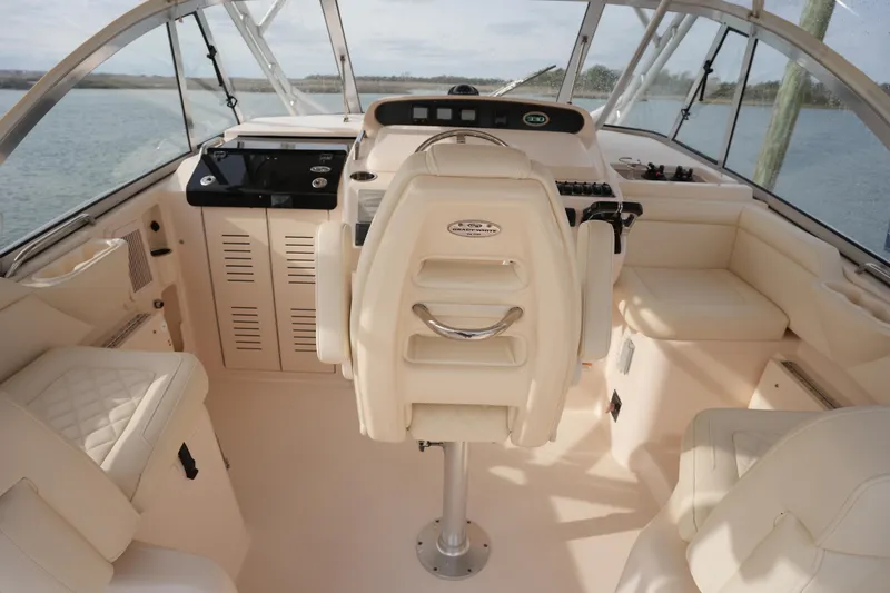 Slide: The Image of 2009 Grady-White Express 330 boat interior with helm and seating area. - 26