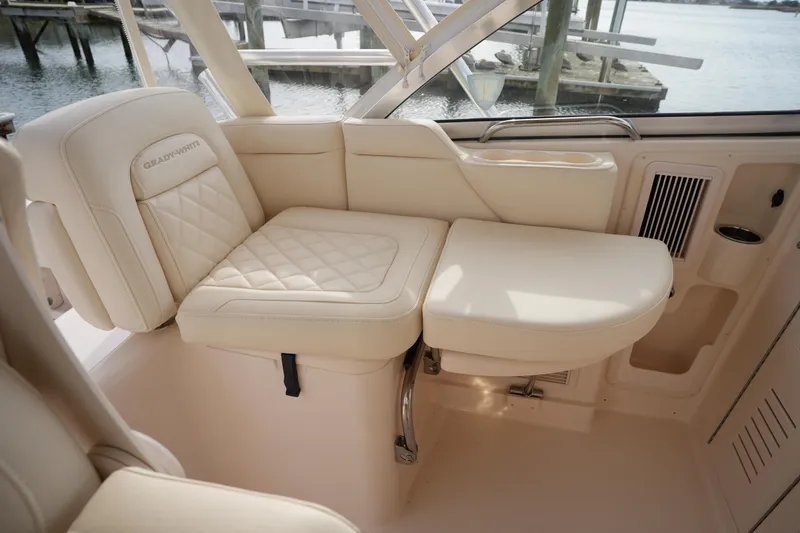 Slide: The Image of Luxurious seating on 2009 Grady-White Express 330 boat, featuring cream upholstery and elegant design. - 29