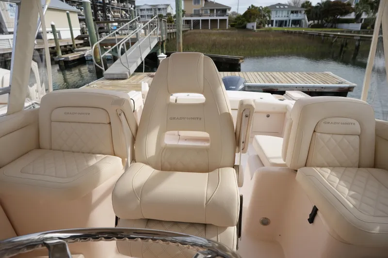 Slide: The Image of Luxurious seating on a 2009 Grady-White Express 330 boat at a dock. - 30