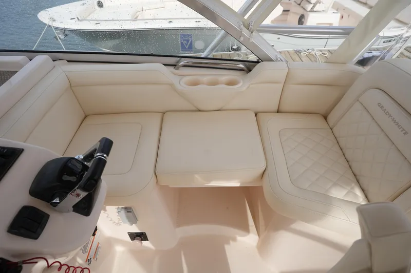 Slide: The Image of Luxurious seating area on a 2009 Grady-White Express 330 boat, featuring cream upholstery. - 32
