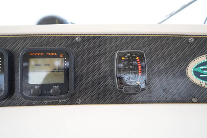 Slide: The Image of Dashboard of 2009 Grady-White Express 330 boat with speed and fuel gauges. - 38