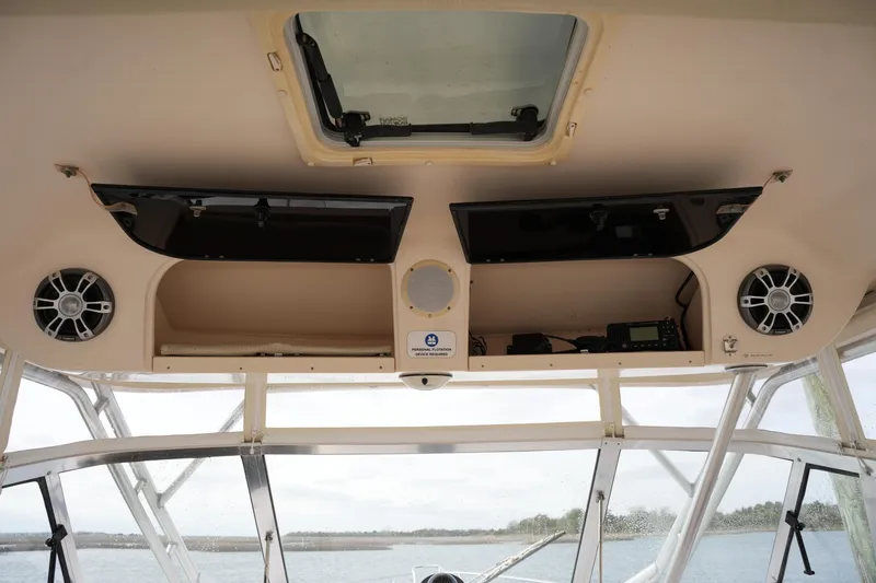 Slide: The Image of Interior view of a 2009 Grady-White Express 330 boat with speakers and storage compartments. - 39