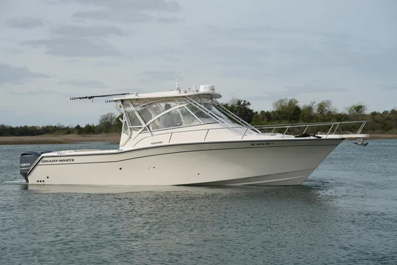 Slide: The Image of 2009 Grady-White Express 330 boat on calm water, side view. - 4