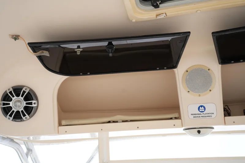 Slide: The Image of Interior of 2009 Grady-White Express 330 boat with speakers and safety sign. - 40