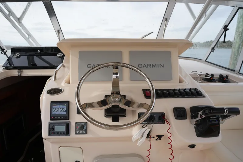 Slide: The Image of Helm of 2009 Grady-White Express 330 with Garmin navigation system and controls. - 42