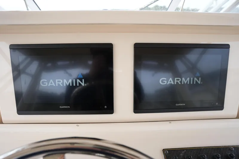 Slide: The Image of Dual Garmin displays on 2009 Grady-White Express 330 boat dashboard. - 43