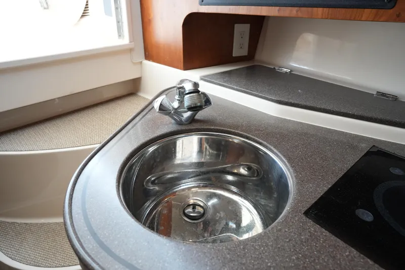 Slide: The Image of Compact kitchen sink in 2009 Grady-White Express 330 boat interior. - 47